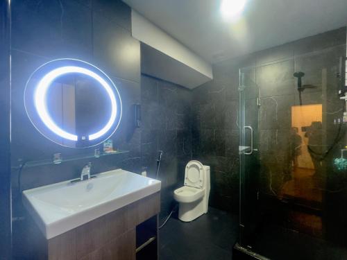 a bathroom with a sink and a toilet and a mirror at Nordic Hostel & Gym l Female Only in Phi Phi Don
