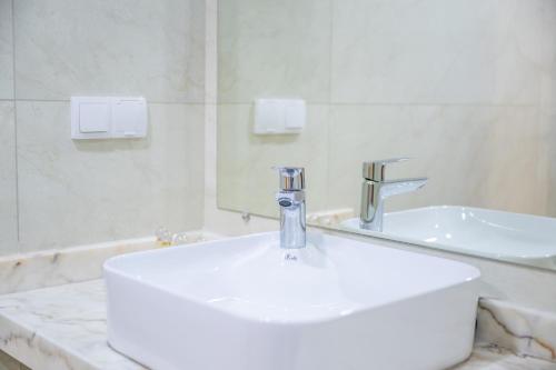 a bathroom with a white sink and a mirror at Very Charming Apartments with balcony, Haut Agdal in Rabat