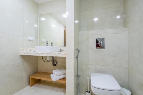 a bathroom with a white toilet and a sink at Very Charming Apartments with balcony, Haut Agdal in Rabat