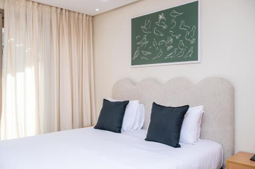 a bedroom with two beds and a chalkboard on the wall at Very Charming Apartments with balcony, Haut Agdal in Rabat