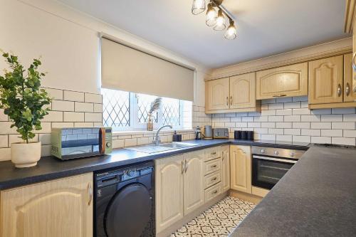 a kitchen with a sink and a dishwasher at Host & Stay - Joffre Avenue in Castleford