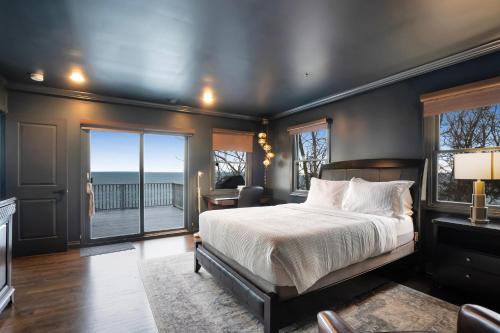 a bedroom with a bed and a view of the ocean at Scenic Gem: Waterfront View, Beach Access in Wading River