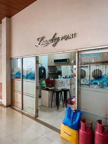 a walmart store with a sign on the wall at 2BR Apartement Sudirman Bandung in Bandung