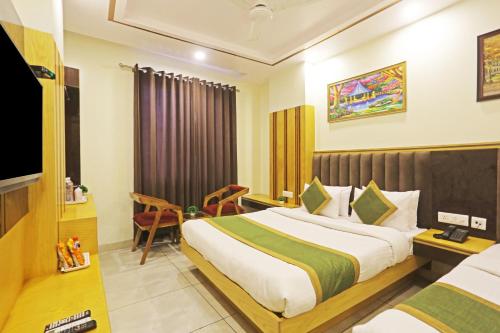 a hotel room with a bed and a television at Hotel Aman Imperial Just a Minute Away From New Delhi Railway Station and Connaught place in New Delhi