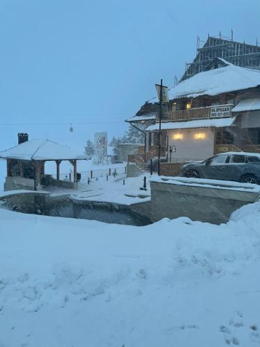 a parking lot covered in snow at night at Jelena Lux Apartmani - Zlatibor - Tornik in Čajetina