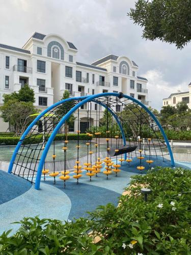 a playground in front of a large building at Thong Dong Homestay in Phước Lý