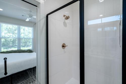 a bathroom with a shower with a glass door at The Betty, on 2 acres Hot tub & 2 King Beds in Hot Springs