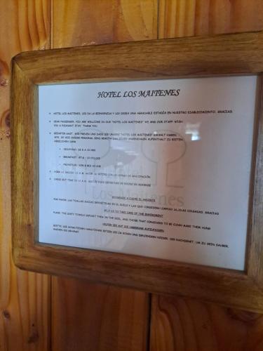 a picture of a menu in a wooden frame at Hotel los maitenes in Pucón