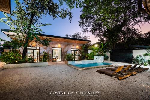 a house with a swimming pool and some chairs at Steps to the Main Surf Break - 3 Bedroom House in Refundores
