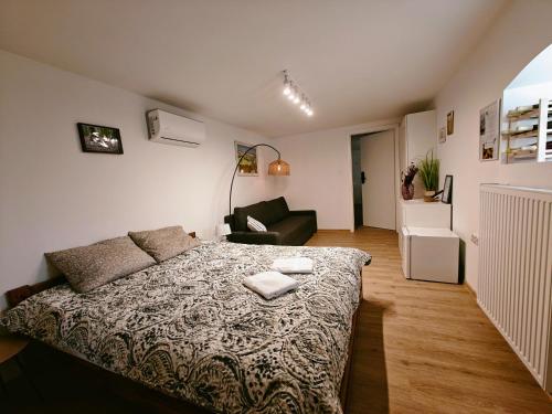 a bedroom with a bed and a living room at Winnica NOVI - apartamenty in Cianowice Duże