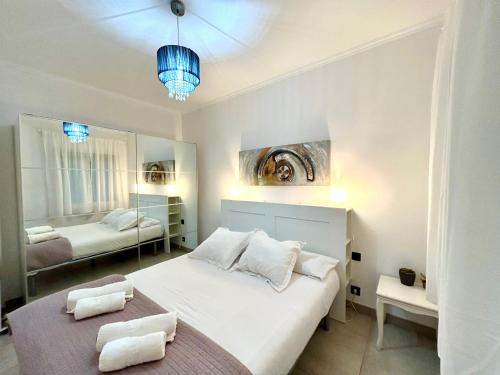 a bedroom with a white bed and a mirror at Apartment Sagrera in Barcelona