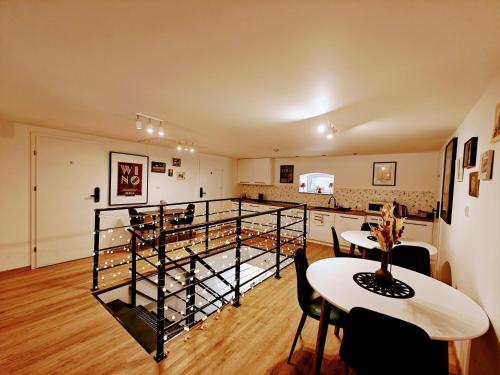 a room with two tables and a wine cellar at Winnica NOVI - apartamenty in Cianowice Duże
