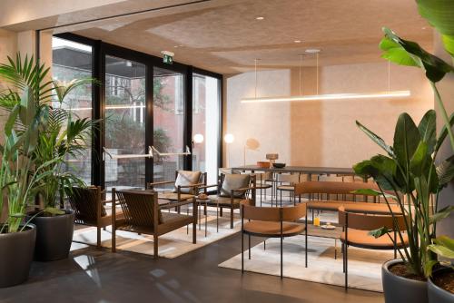 a restaurant with tables and chairs and plants at master Trevi in Rome