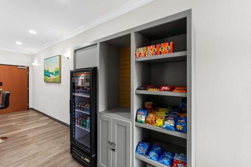 a walk in pantry with a black refrigerator at Sonesta Essential Beaumont in Beaumont