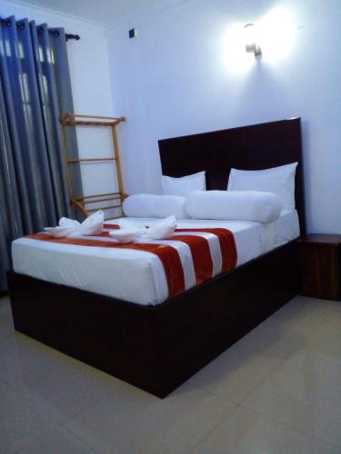 a bedroom with a large bed in a room at Wilroma Hotel&Resort in Anuradhapura
