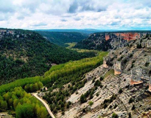 an aerial view of a canyon with a road at El Fronton in Vadillo