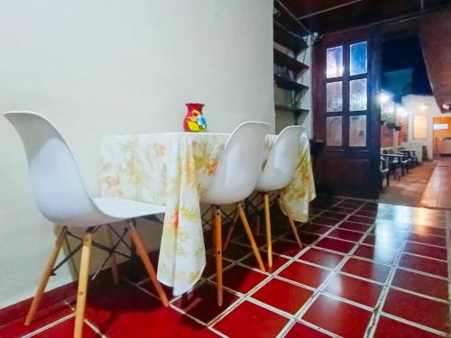 a row of white chairs sitting around a table at Casa Central de Santa Ana in Santa Ana