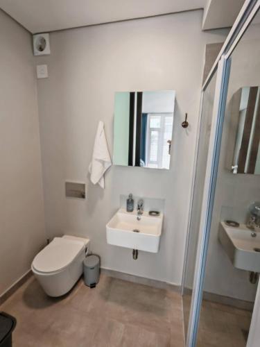 a bathroom with a toilet and a sink at Bellamare Royal in Summerstrand