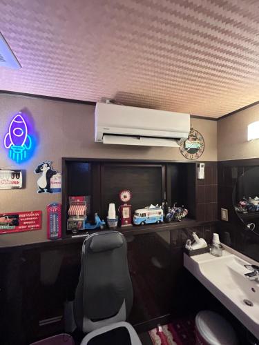 a bathroom with a sink and a desk with a chair at Ryoso Chatani in Kyoto