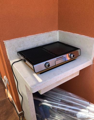 a toaster oven sitting on top of a shelf at Apartment Dertil Premantura in Premantura