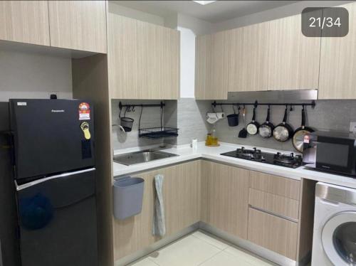 a small kitchen with a sink and a stove at Wallaway2stay Gravit8 Andaman Klang 2 Queen Room in Klang