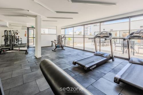 a gym with treadmills and elliptical machines at Belo Estúdio Elegante em Poço de Caldas PGO0205 in Poços de Caldas