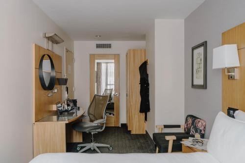 a hotel room with a bed and a desk at World Center Hotel in New York