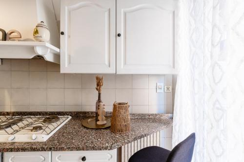 a kitchen with white cabinets and a counter top at Case da Amare - Casa Tobia in Alassio