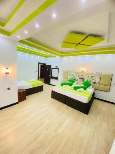 a large room with two beds in it at Wilroma Hotel&Resort in Anuradhapura
