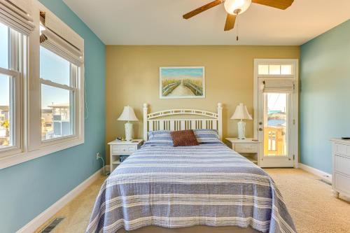 a bedroom with a bed with blue walls and windows at Chic Surf City Retreat with Pool Less Than 1 Block to Beach! in Surf City