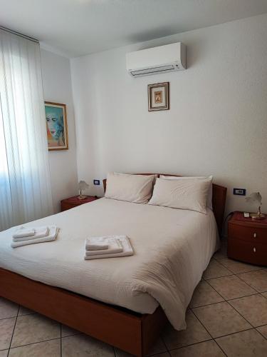 a bedroom with a bed with two towels on it at IL GIRASOLE in Tirano