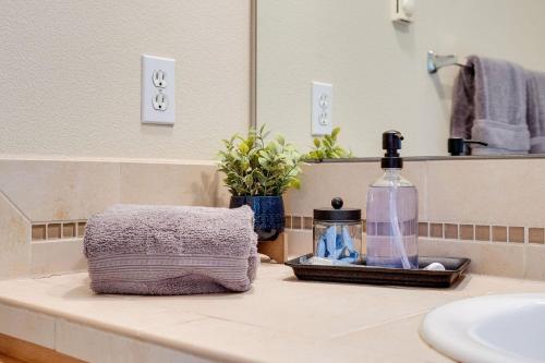 a bathroom counter with a sink and a bottle of soap at Perch - Florentia Residence in Seattle