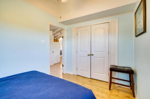 a bedroom with a blue bed and a stool at 5 Mi to Beach Bay St Louis Home with Launch and Dock in Shoreline Park