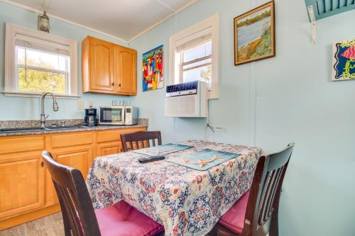 a kitchen with a table and chairs and a kitchen with a sink at Studio about 5 Mi to Waveland Beach and Pier! in Shoreline Park