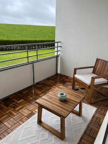 a balcony with a chair and a table on a balcony at Meerliebe in Cuxhaven