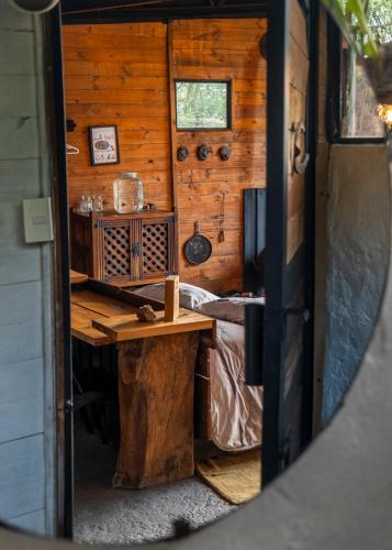 a room with a table and a bed in a cabin at Cabañas de montaña en Chía - Satorinatural in Chía