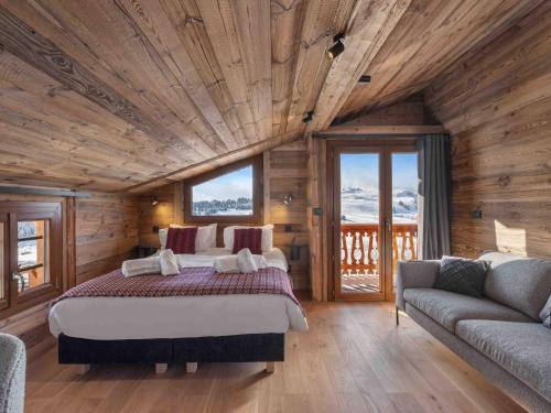 une chambre avec un grand lit dans une pièce en bois dans l'établissement Chalet pour 10 avec sauna et confort à Les Saisies - FR-1-809-11, aux Saisies