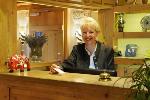 a woman sitting at a counter in a room at Hotel Bellerive Gstaad in Gstaad