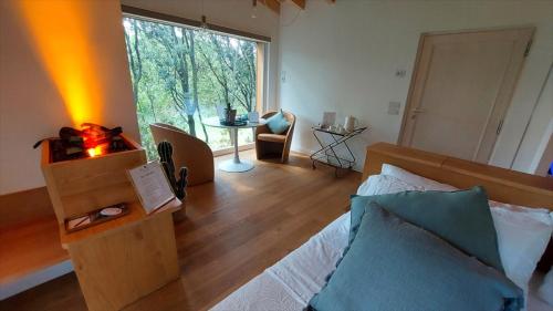 a bedroom with a bed and a large window at Le Case Resort in Macerata