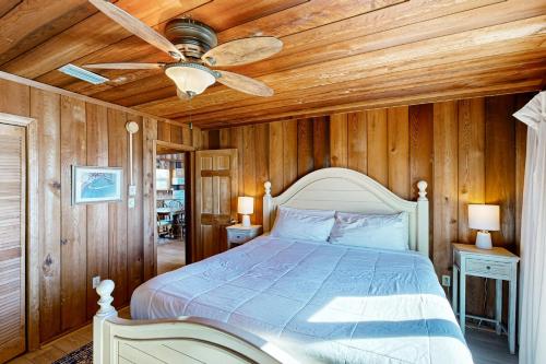 a bedroom with a bed with a ceiling fan at As Pelicans Pass in Indian Pass