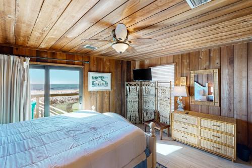 a bedroom with a bed and a ceiling fan at As Pelicans Pass in Indian Pass