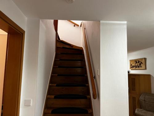a staircase in a room with a white wall at Ferienhaus Conny in der Bauhausstadt Dessau in Dessau