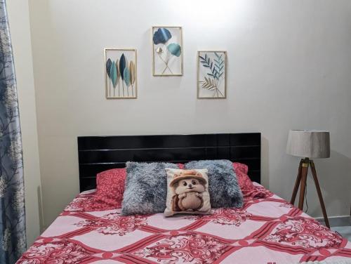 a bedroom with a bed with a stuffed animal on it at Elite Premium 1BHK in Bengaluru