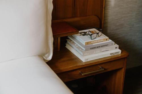 a stack of books on a nightstand next to a bed at Hotel Boutique at Grand Central in New York