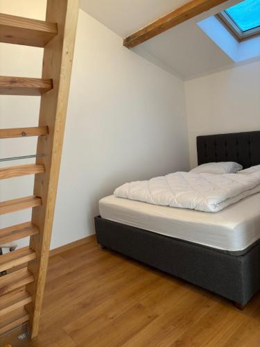 a bedroom with a bed and a staircase at Les Balcons de L'Izoard in Arvieux