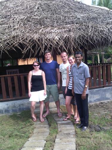a group of people standing in front of a building at Eco Cabanas Marakolliya in Tangalle