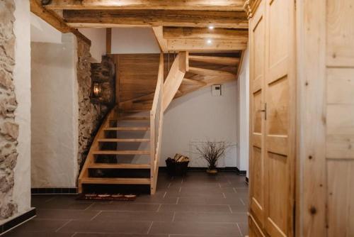 a hallway with a wooden staircase in a building at Luxuriöse Schwarzwald Loft Heustock mit Sauna und Whirlpool am Griesbachhof in Titisee-Neustadt