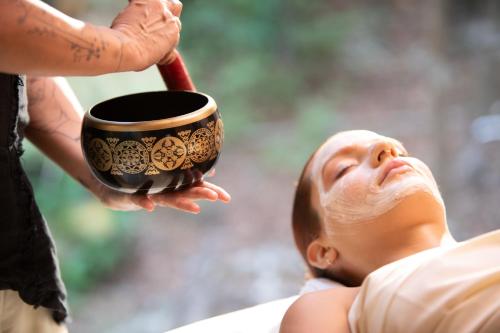a person holding a pot with a head on a man at Palmaïa The House of AïA All Inclusive Wellness Resort in Playa del Carmen