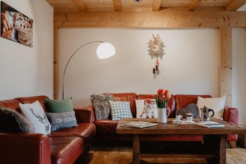 a living room with a couch and a table at Luxuriöse Schwarzwald Loft Heustock mit Sauna und Whirlpool am Griesbachhof in Titisee-Neustadt