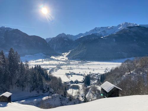 a view of a snow covered valley with mountains at Appartment Elfi in Uttendorf